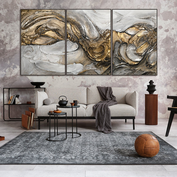The painting "Tsunami" is an abstract triptych in gold and silver tones