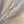 The painting “Sands and Clouds” — light abstract swirls on canvas