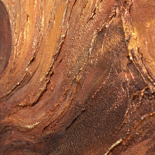 The painting “Amber Flows” is an abstract work in golden brown tones