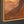 The painting “Amber Flows” is an abstract work in golden brown tones