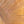 The painting “Warmth Whirlwind” is a textured abstraction in golden-copper tones.