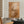 The painting “Warmth Whirlwind” is a textured abstraction in golden-copper tones.