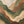 The painting “Dance of the Hills” is an abstract landscape in green tones