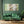 The painting “Quiet Harbor” is an abstract softness of green and gold