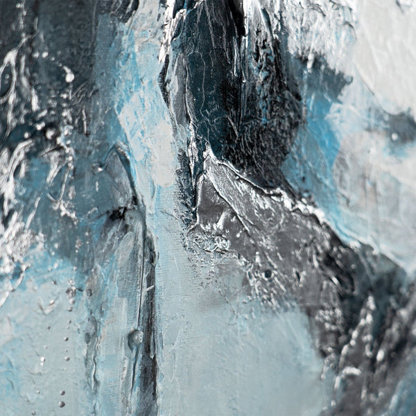 The painting "Ice Abstraction" is a contrast of white and charcoal against a sky-blue background.