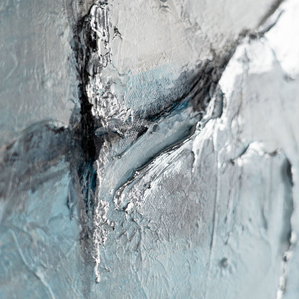The painting "Ice Abstraction" is a contrast of white and charcoal against a sky-blue background.