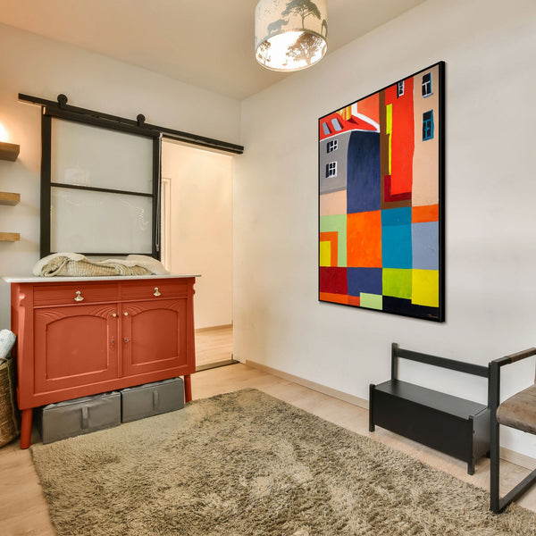The painting "City in Color" is a bright geometric abstraction with architectural motifs