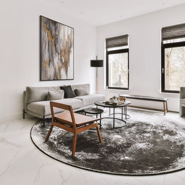 The painting "Traces of Time" is a vertical abstraction with charcoal-gray and bronze-gold tints.