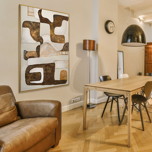 The painting "Rhythm of the Earth" is a vertical abstraction in brown and sand tones.